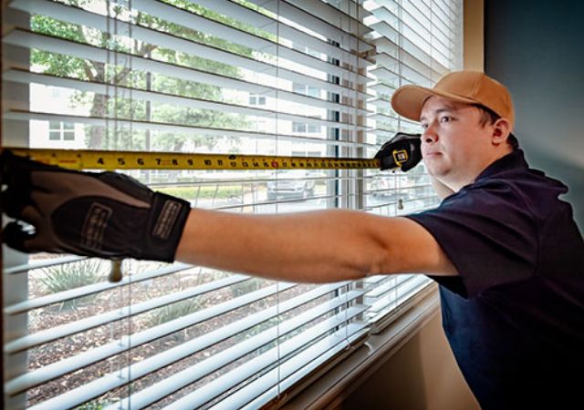 Man Measuring Blinds